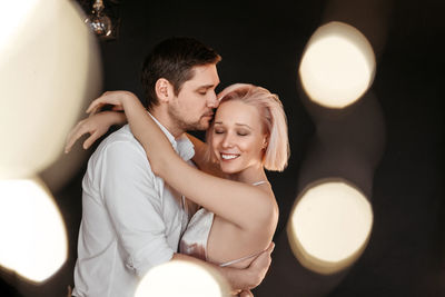 Young couple kissing in the dark