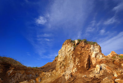 Low angle view of rock formations against sky