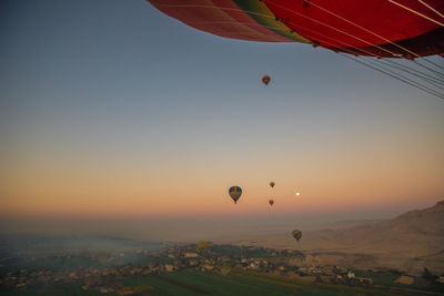 Hot air balloon flying in sky during sunset