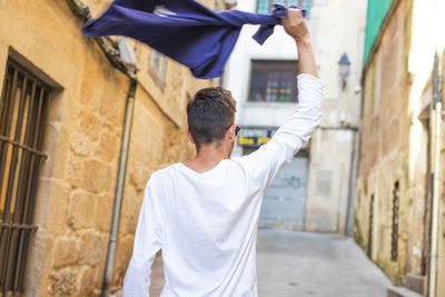 Young man having fun and celebrating in the street