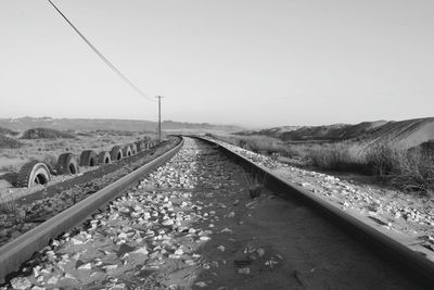 Surface level of railroad tracks against clear sky