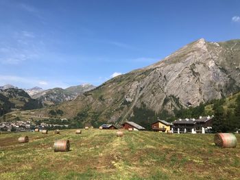 Scenic view of field and houses against sky