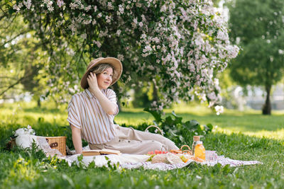 Portrait of young woman sitting on field