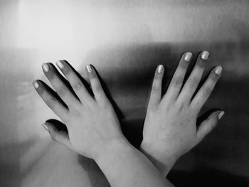 Close-up of hands touching wall