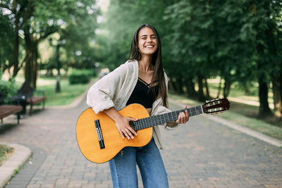 Young woman playing guitar