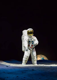 Light painting of person against black background at night