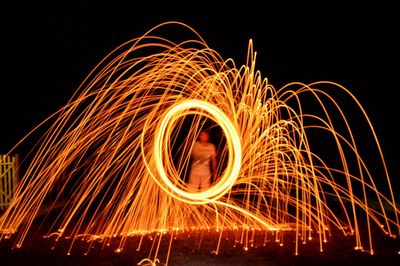 Man with wire wool at night