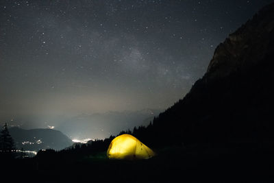 Scenic view of silhouette mountains against sky at night