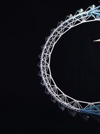 Low angle view of ferris wheel against sky at night