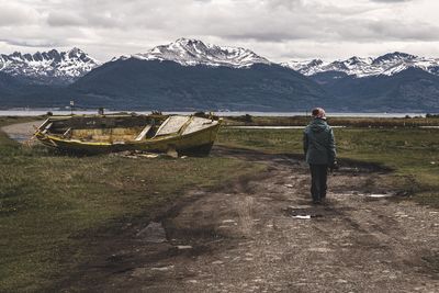 Rear view of man walking on field