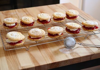 Close-up of viennese whirls on rack at wooden table