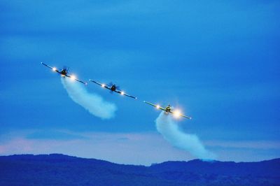 Low angle view of airshow against sky