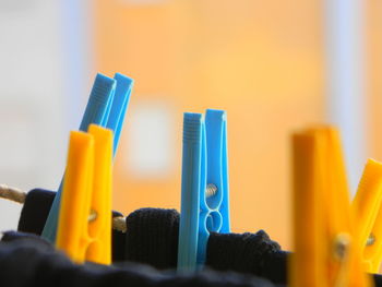 Close-up of yellow and blue clothespins