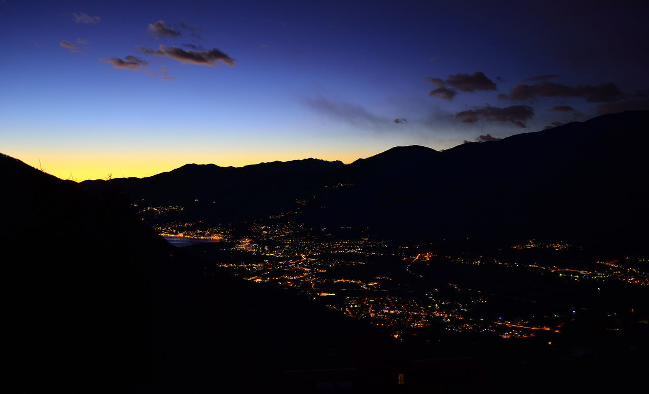 SILHOUETTE CITYSCAPE AGAINST SKY AT NIGHT