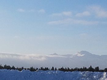 Scenic view of snow mountains against blue sky