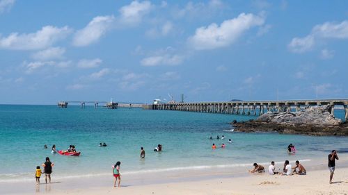 People on beach against sky