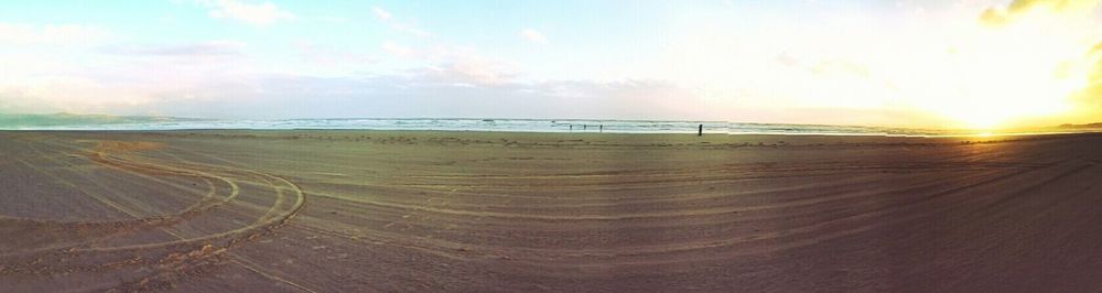 Scenic view of beach against sky during sunset