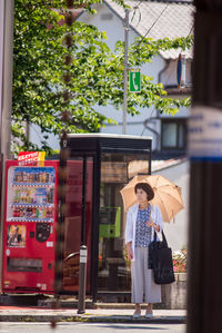 Full length of woman walking on street in city