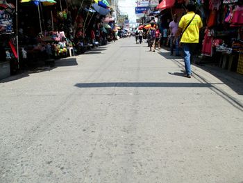 People walking on footpath in city