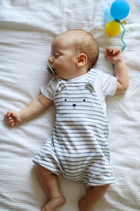 Cute baby girl lying on bed