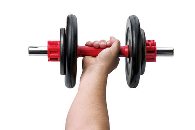 Close-up of hand holding pen against white background