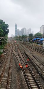High angle view of railroad tracks in city against sky