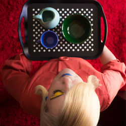 High angle view of woman holding cutlery in tray