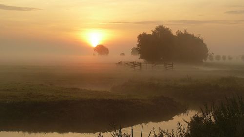 Scenic view of landscape against sky during sunset