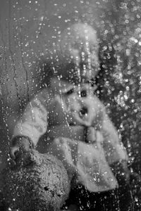 Portrait of cute girl in water drops on woman