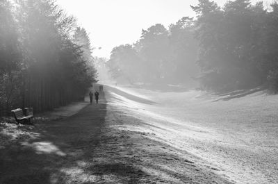 Man walking on road in winter