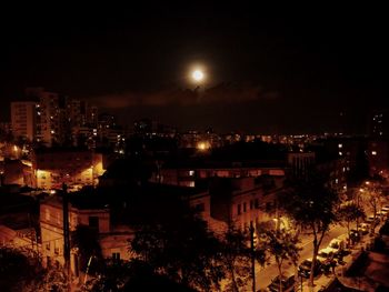 Illuminated cityscape against sky at night