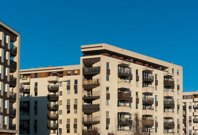 Low angle view of buildings against clear blue sky