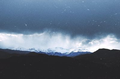 Scenic view of mountains against sky at night