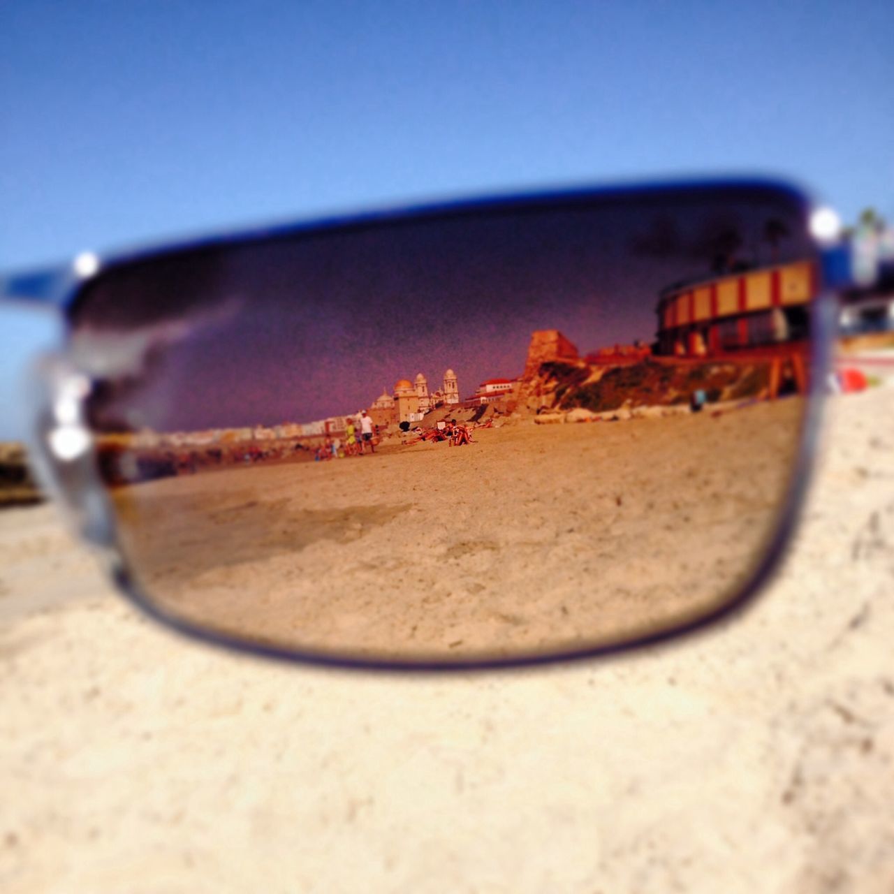 transportation, focus on foreground, close-up, selective focus, mode of transport, clear sky, land vehicle, beach, abandoned, sand, sky, rusty, metal, surface level, damaged, nautical vessel, outdoors, no people, car, obsolete