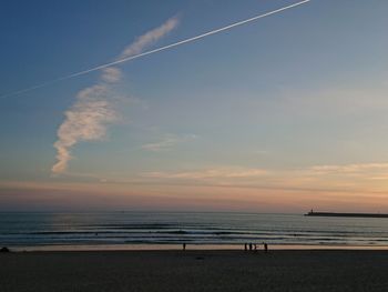 Scenic view of beach against sky during sunset