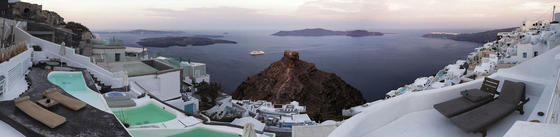 Panoramic view of sea and buildings against sky