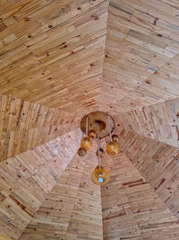 High angle view of light bulbs hanging on wooden floor