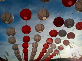 Low angle view of lanterns hanging against sky