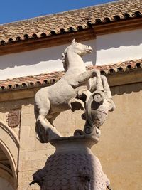 Low angle view of statue against temple