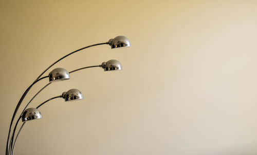 Close-up of electric lamp against wall