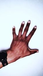 Close-up of hand against white background