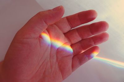 Close-up of hand holding rainbow
