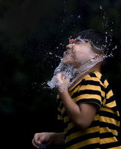 Full length of boy splashing water