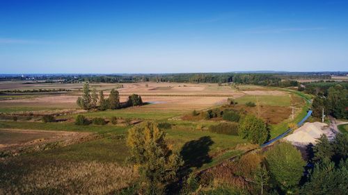 Autumn countryside landscape with a cloudless blue sky as seen from a drone