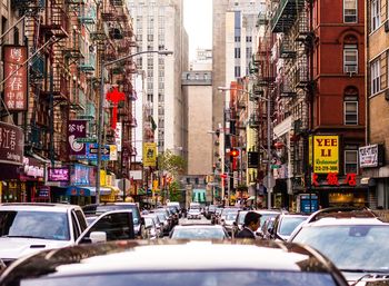 View of traffic on road amidst buildings in city