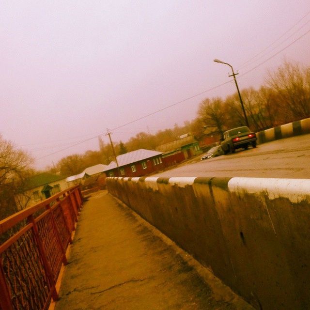 the way forward, connection, transportation, diminishing perspective, built structure, architecture, vanishing point, tree, railroad track, clear sky, long, sky, bridge - man made structure, rail transportation, railing, outdoors, no people, building exterior, power line, walkway