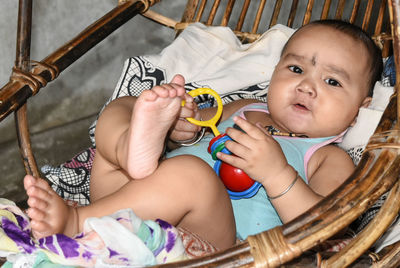 Portrait of baby boy relaxing on swing