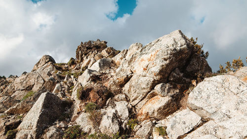 Top of a dry mountain with stones and gray soil