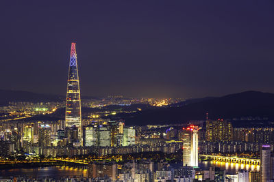 Illuminated buildings in city at night