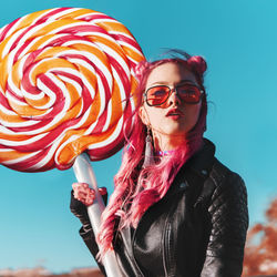 Portrait of beautiful woman with red umbrella